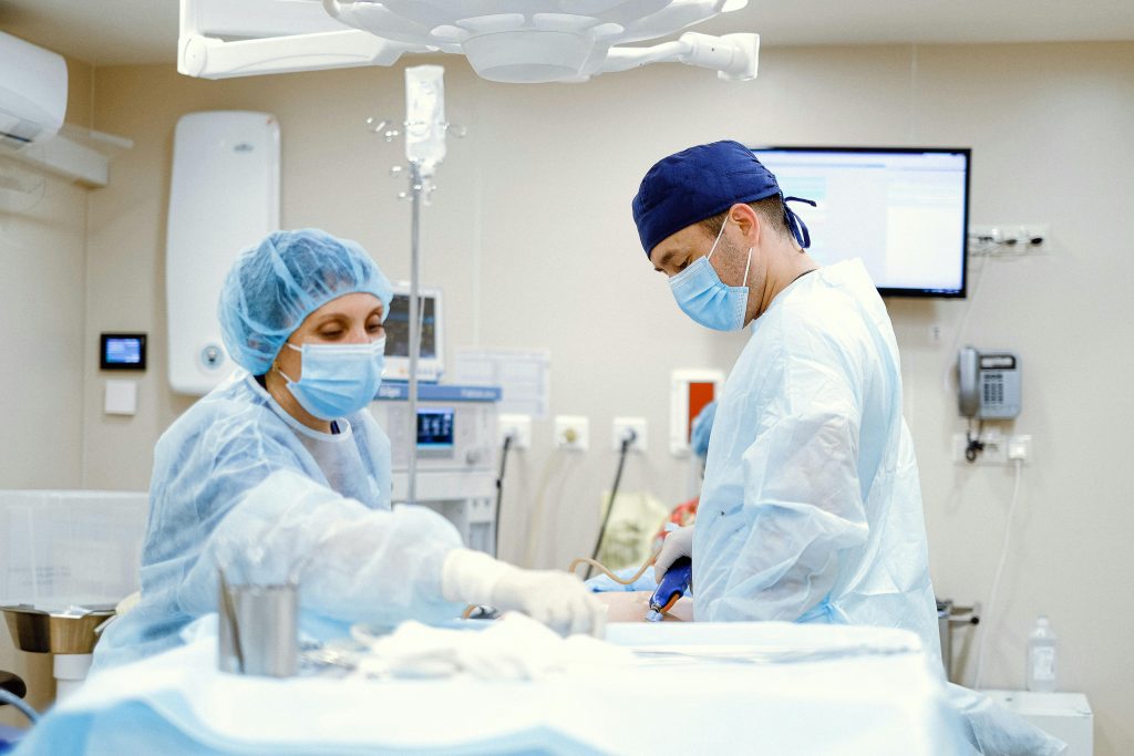 Team of doctors and nurses in an operating room performing surgery with focus and precision.